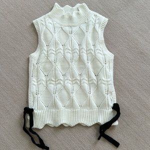 Sleeveless sweater cute black ties on side, but can be removed